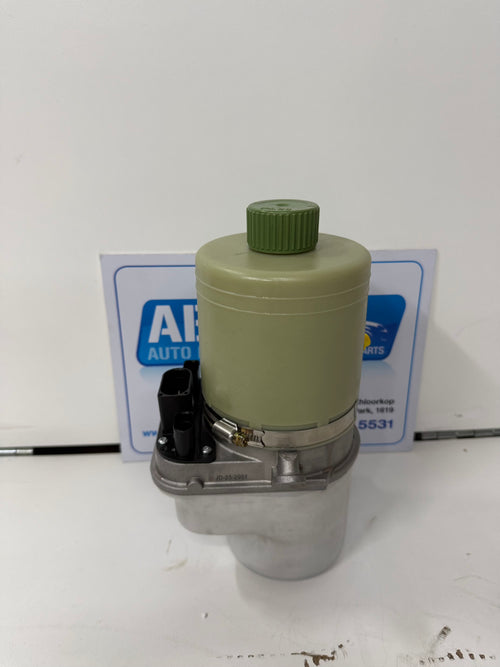 Mechanical component with green cap on a white background, brand 'AB' visible