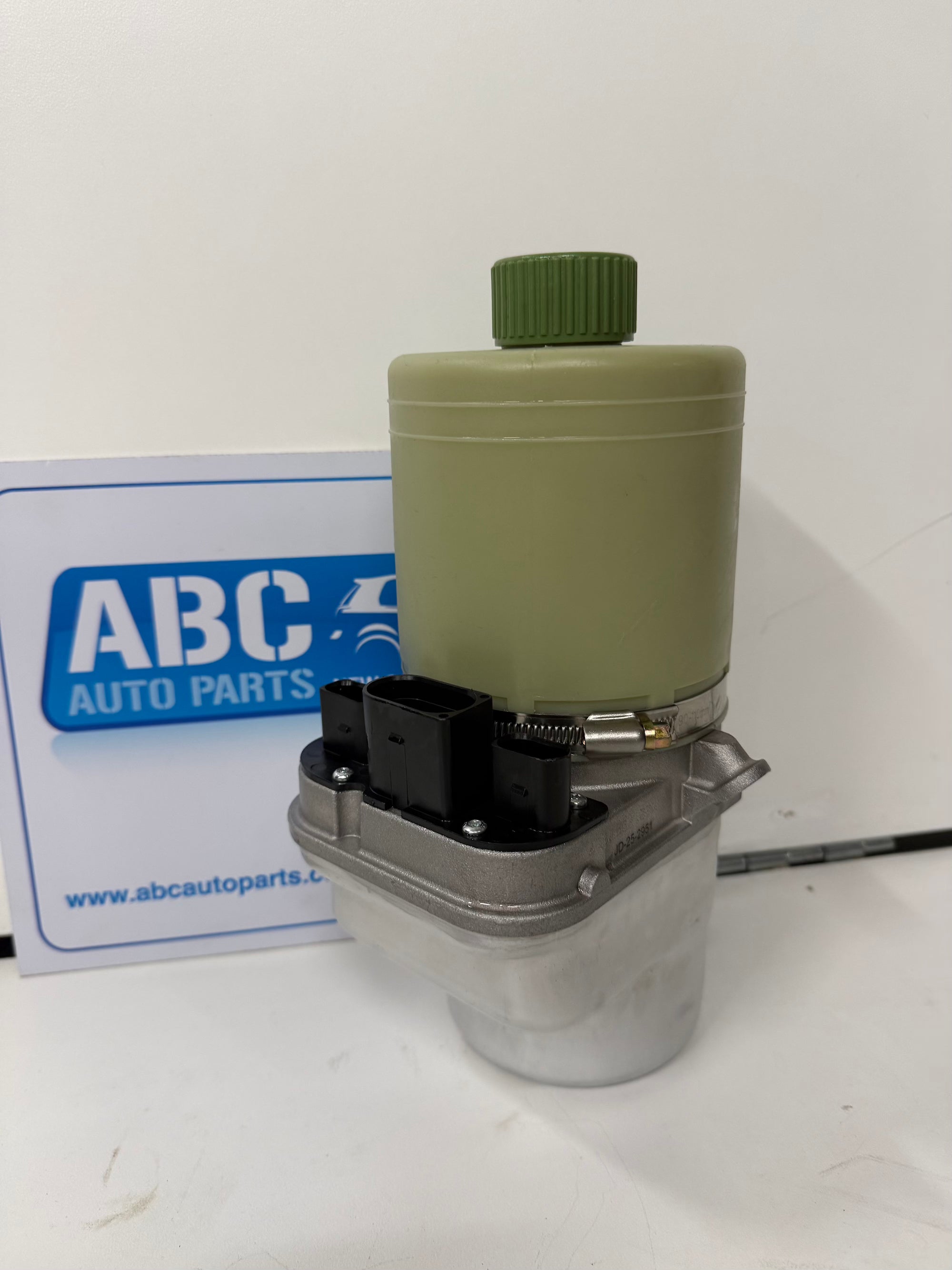 Mechanical component with green cap on a white background, featuring ABC Auto Parts branding.