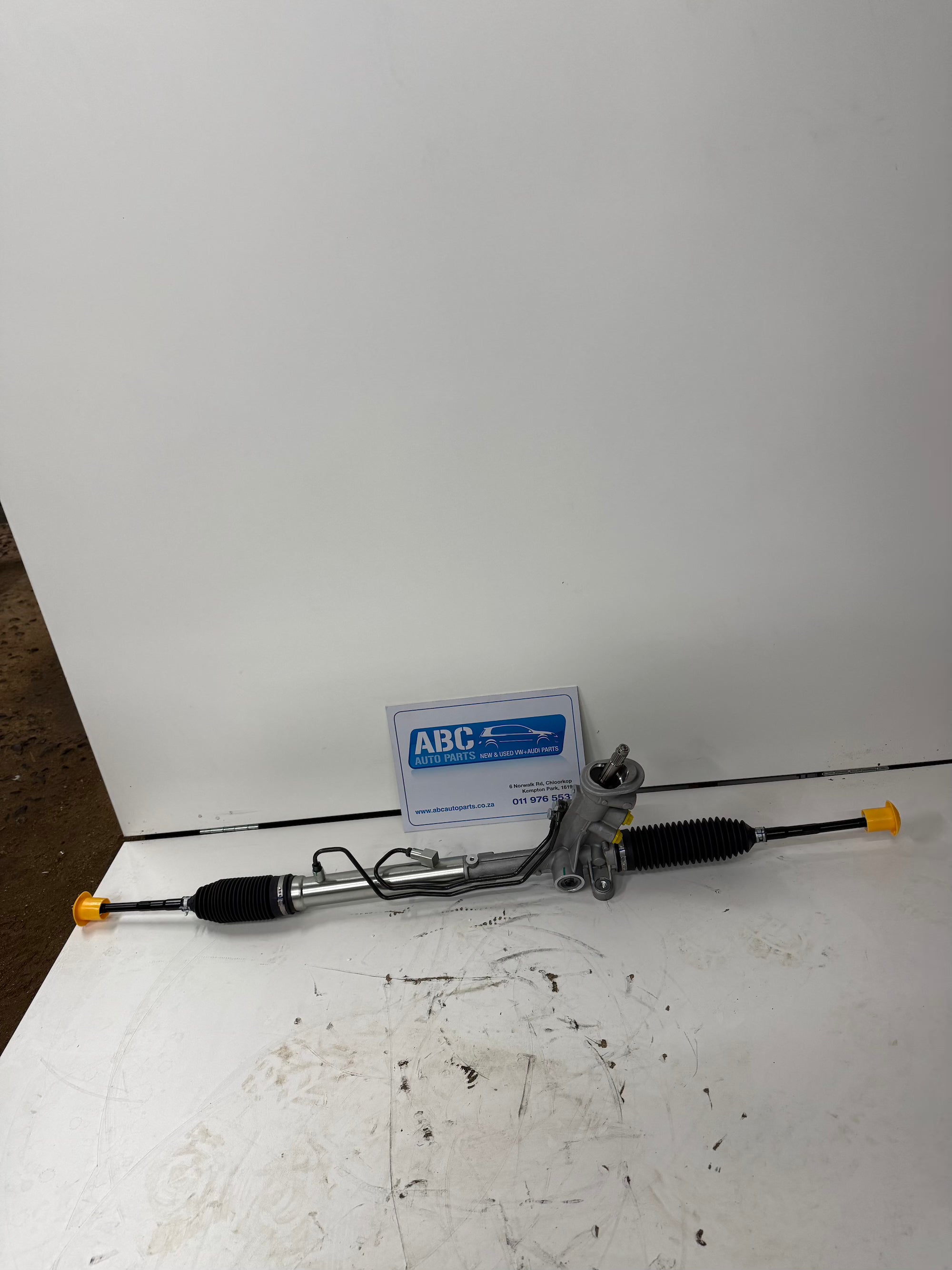 Car steering rack on a white surface with a white background