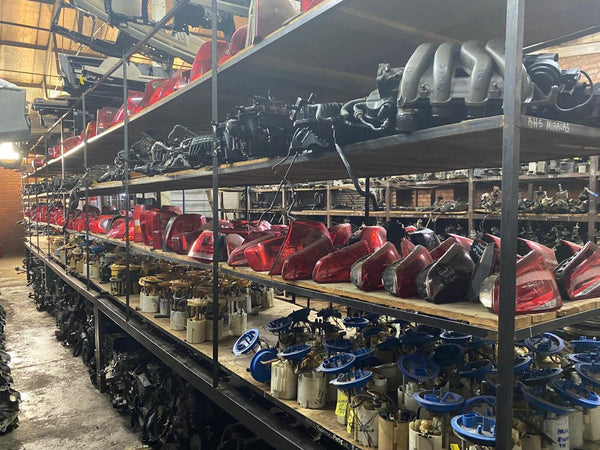 Shelves with VW and Audi car parts in a warehouse setting