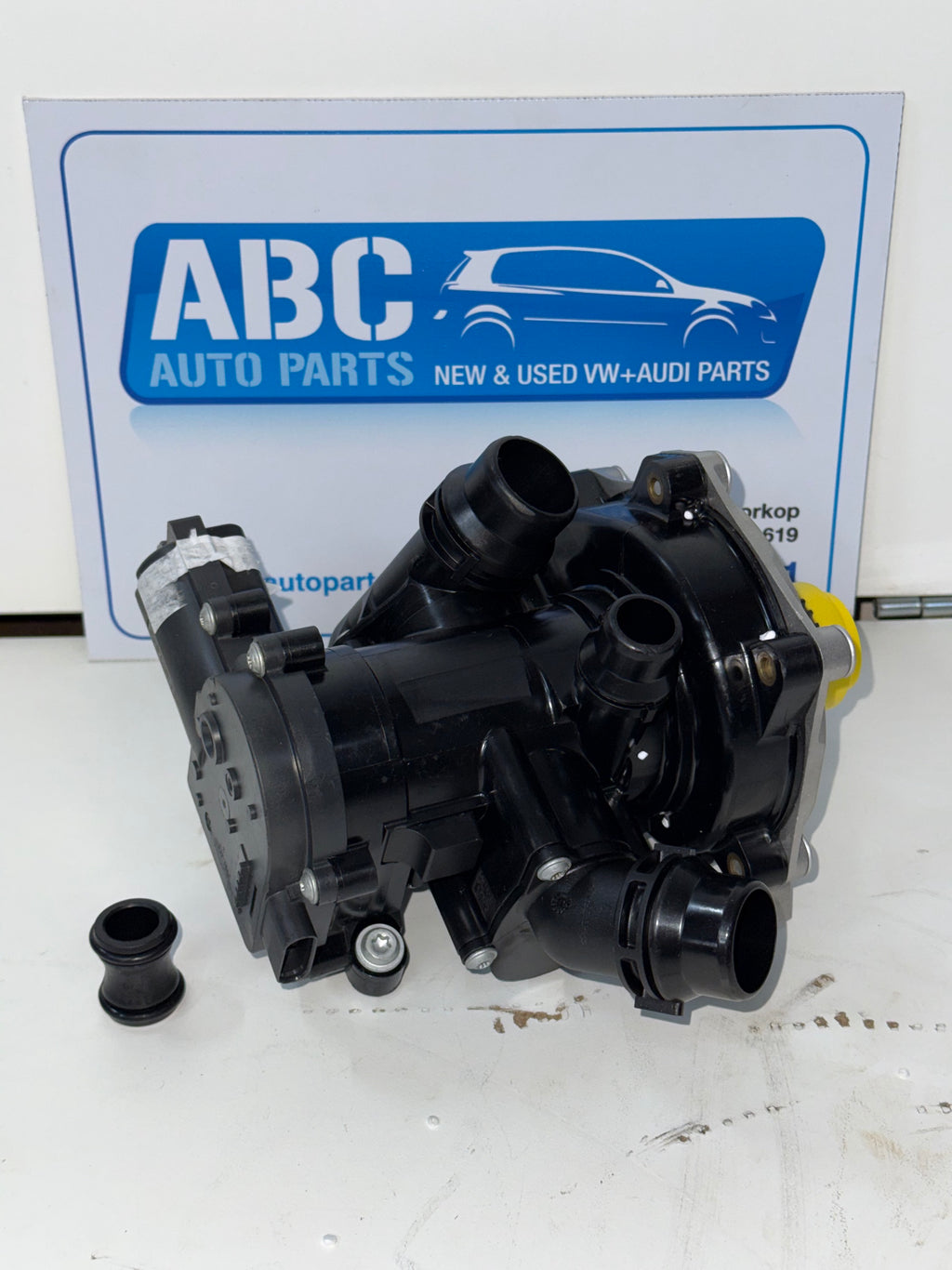 Car water pump with ABC Auto Parts logo in the background